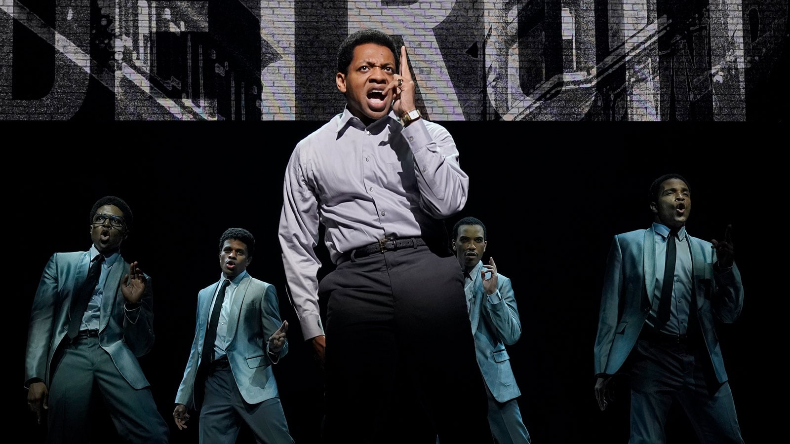 (foreground) Derrick Baskin (Otis Williams); (background, l to r) Ephraim Sykes (David Ruffin), Jeremy Pope (Eddie Kendricks), Jared Joseph (Melvin Franklin), and James Harkness (Paul Williams) in the world premiere of <em>Ain’t Too Proud—The Life and Times of The Temptations</em> at Berkeley Repertory Theatre.